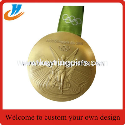 Polished gold Olympic games medals with ribbon, Olympics trophy and award medals